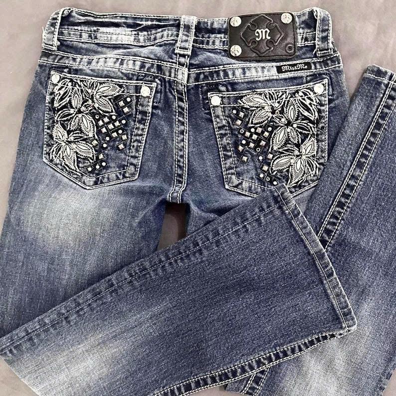 women's bootcut jeans, miss me? 2000’s floral embellished low-rise bootcut jeans. medium-wash vintage grunge mcbling styled piece.